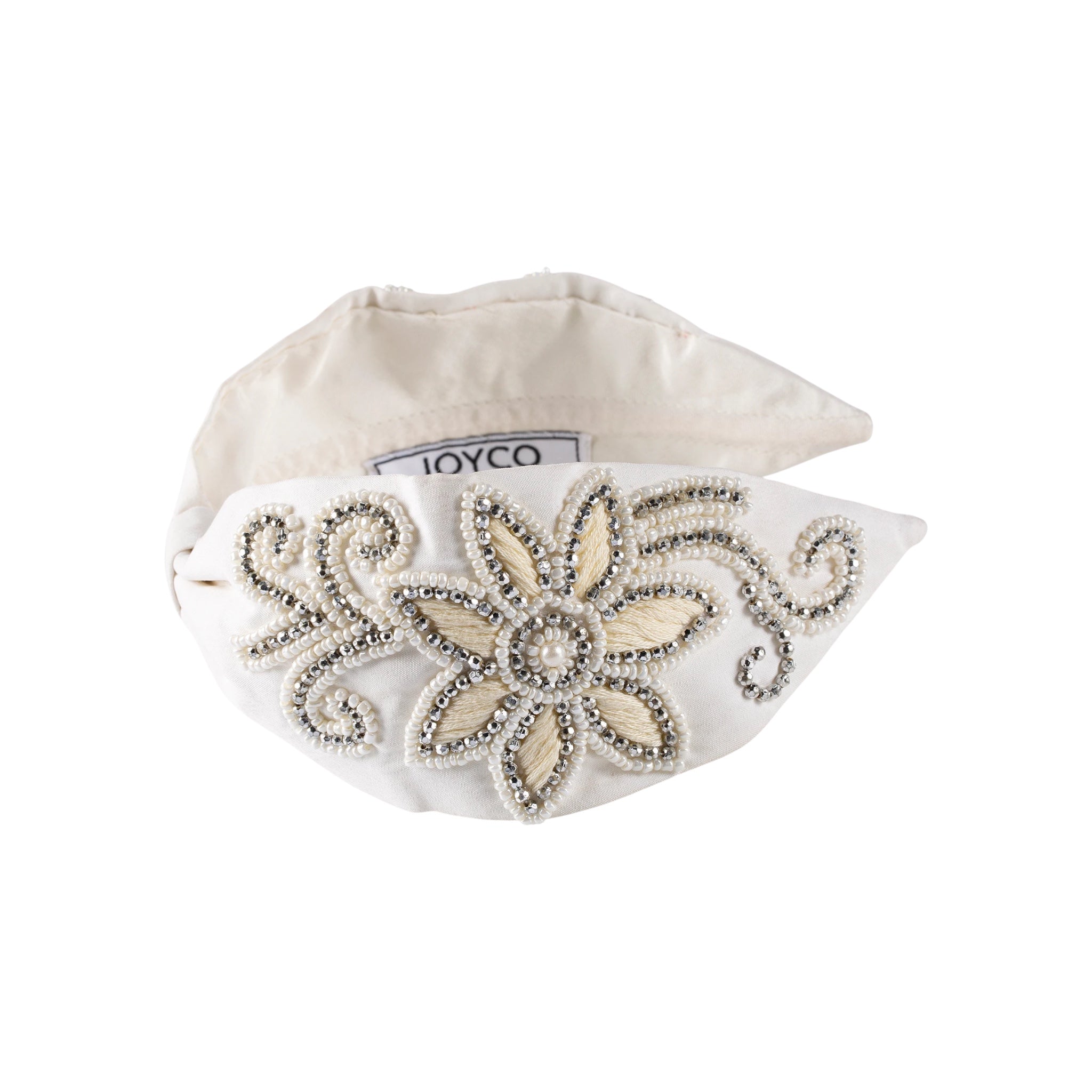 JOYCO ivory satin headband with intricate pearl and rhinestone floral embroidery and swirling bead details.